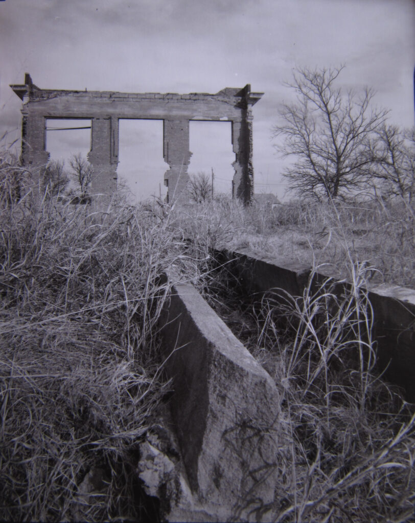 The facade and foundation of an abandoned church in rural Oklahoma.